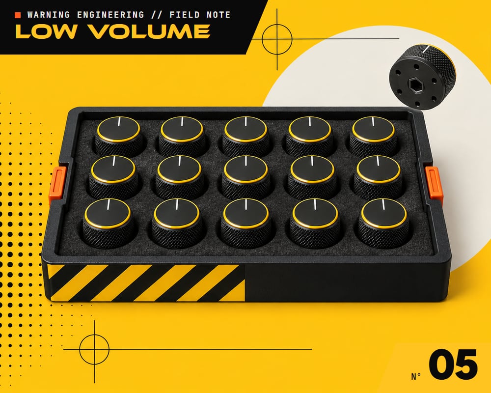 A foam tray with a grid of identical machined knobs, one lifted out and turned over